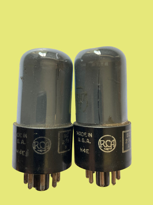 Two vintage RCA vacuum tubes on a white background