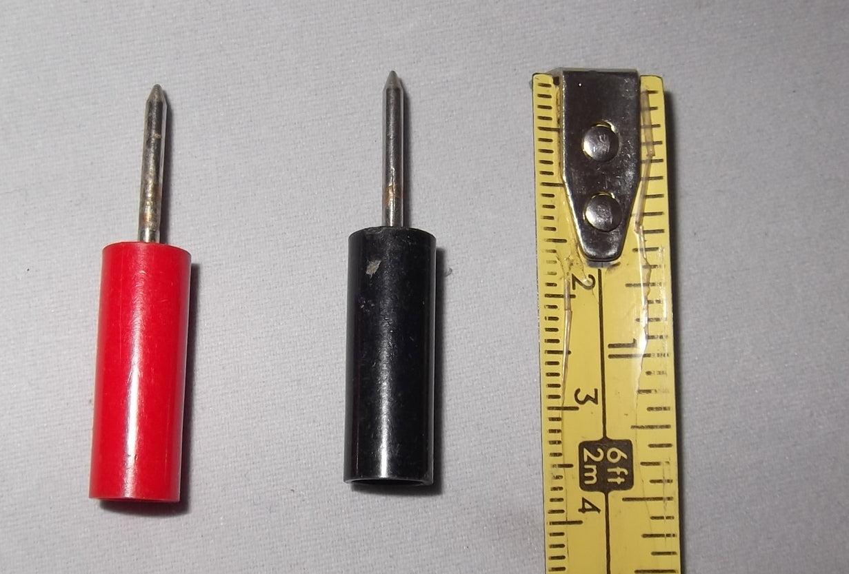 PAIR OF BLACK & RED SHARPENED PRONG PLUGS APPROX 2MM DIA