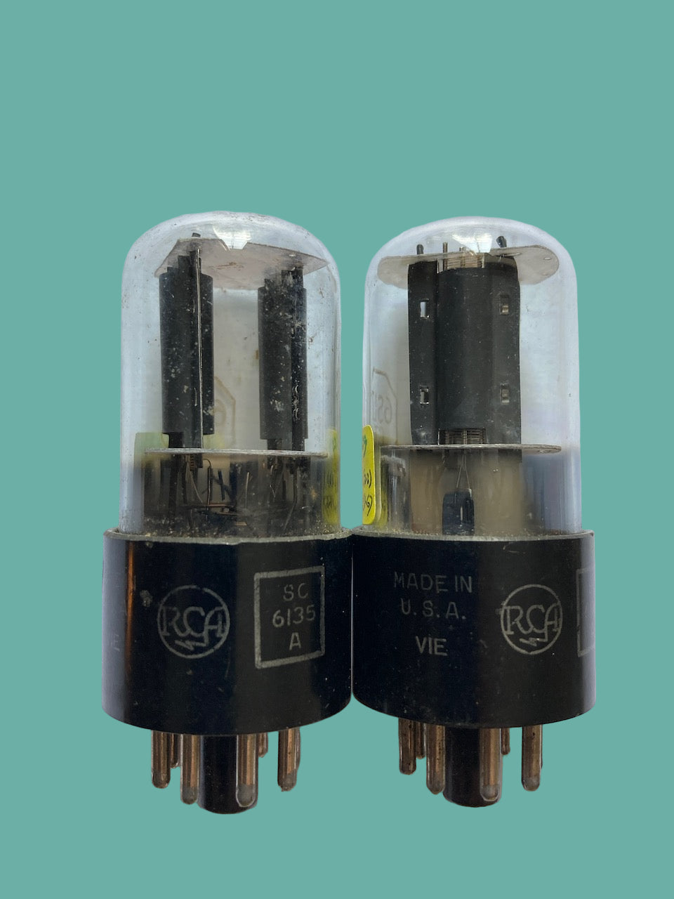 Two vacuum tubes with RCA branding on a white background