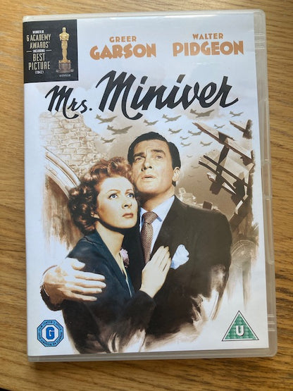 DVD cover of 'Mrs. Miniver' featuring Greer Garson and Walter Pidgeon on a wooden surface.