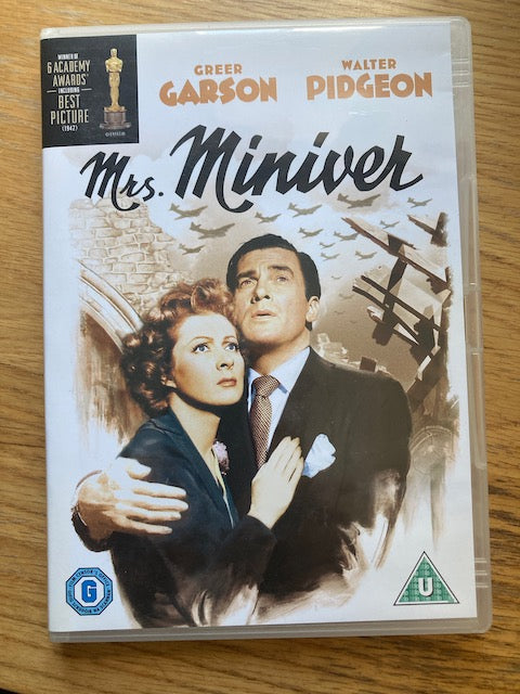 DVD cover of 'Mrs. Miniver' featuring Greer Garson and Walter Pidgeon on a wooden surface.